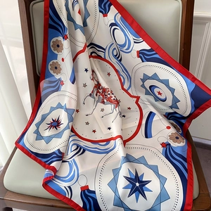 Detailed view of horse print silk scarf draped over a chair showing luxury texture