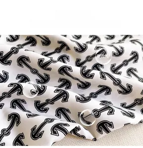 Macro detail of high-quality silk scarf fabric with classic black anchor print pattern