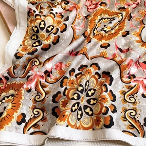 Detailed macro view of vintage mandala floral print on silky summer scarf fabric