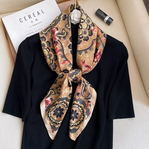 Detailed view of vintage baroque print silk scarf styled with an elegant knot on clothing