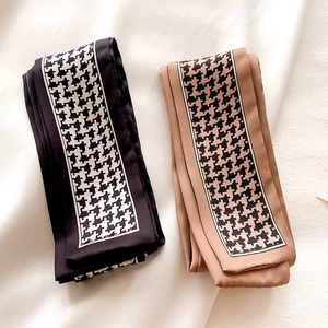 Detailed texture of leopard and houndstooth pattern skinny silk scarves in black and camel