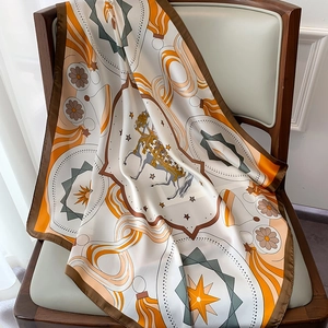 Detail of a vintage carousel silk scarf draped on a chair showing the satin texture