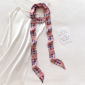 Pink silk Twilly scarf with cat print and geometric patterns on white satin dress