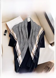 Flat lay of a houndstooth silk scarf with chic accessories for a high-fashion look