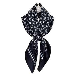 Black and white silk scarf with nautical anchor patterns and a camellia accessory