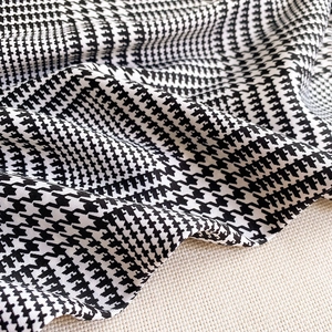 Detailed view of the classic black and white houndstooth pattern fabric with fine texture