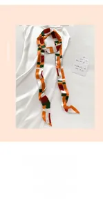 Détail d'un foulard en soie avec motifs géométriques en blocs orange et vert vifs