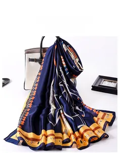 Detail of silk scarf with vintage carriage pattern draped over a white luxury handbag