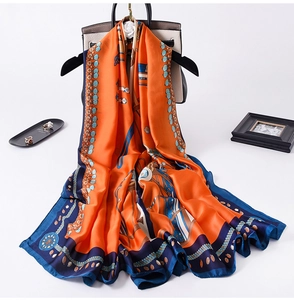 Detail of vintage carriage chain pattern silk scarf with bright orange and navy accents