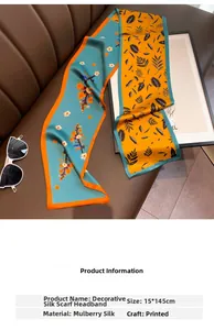 Detail of printed mulberry silk scarf with floral patterns on leather background
