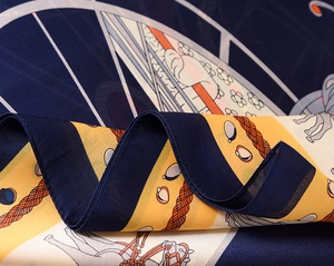 Detailed macro view of vintage silk scarf showing carousel patterns and satin texture