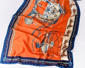 Detailed close-up of orange vintage carriage print on luxury lightweight silk scarf shawl