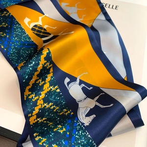 Detail of equestrian silk scarf with horse print and polished satin texture finish