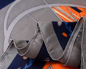 Macro detail of silk scarf showing vintage chain pattern and fine stitched edges
