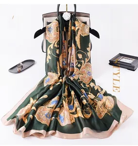 Detail of silk-like long scarf with baroque prints and gold floral patterns