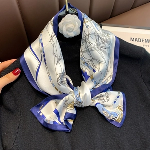 Close-up of nautical silk scarf with navy sailboat prints on premium satin fabric