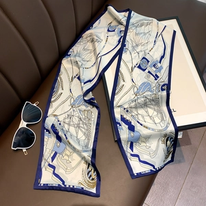Detail of the nautical print silk scarf featuring vintage sailboats and anchor patterns