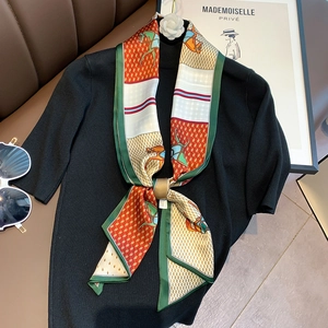Detailed view of silk scarf with equestrian horse print and gold metal ring buckle