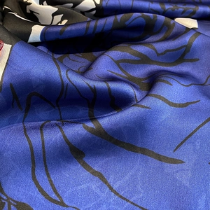 Close-up of vintage printed silk scarf with abstract patterns and smooth satin texture