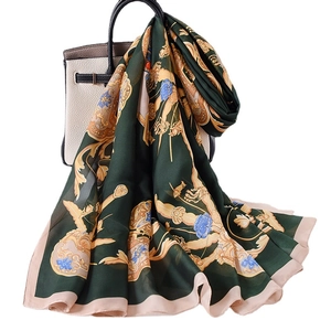 Green baroque floral print silk scarf styled on a handbag for a luxury fashion look