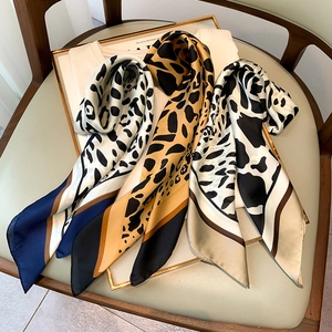 Three-color leopard print silk scarves in navy, mustard, and champagne for women