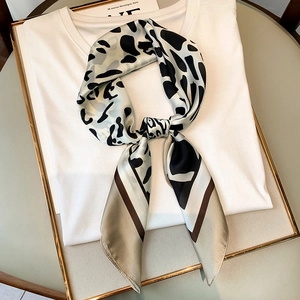 Elegant leopard print silk scarf with geometric color block ends on white background