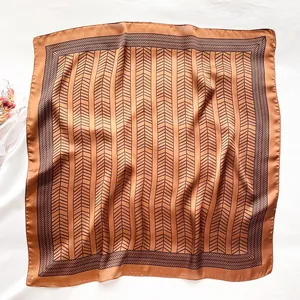 Detail showing the bronze herringbone silk scarf with elegant satin finish and fine texture