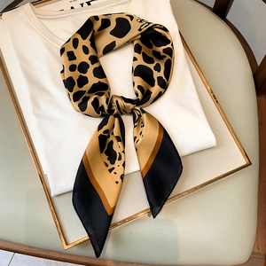 Elegant leopard print silk scarf for women styled as a neckerchief on a white t-shirt