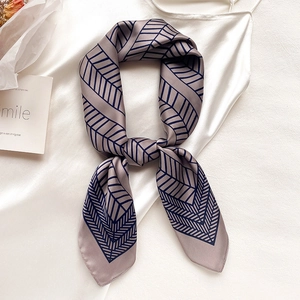 Elegant grey-purple silk scarf with dark blue geometric patterns and soft satin finish