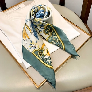 Detail of vintage floral square silk scarf with satin finish on white t-shirt collar