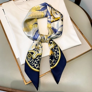 Floral silk scarf for women featuring blue baroque patterns on a white t-shirt display