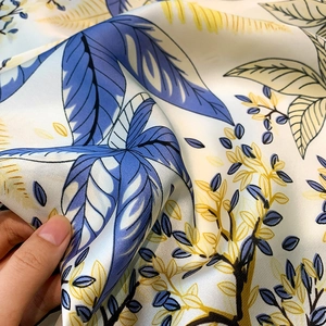 Macro detail of high-quality floral silk fabric showing smooth texture and drape