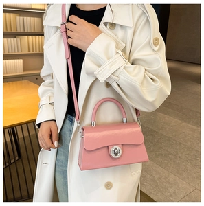 Détail du sac boîte en cuir verni rose avec fermoir en métal argenté et fine bandoulière