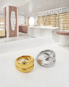 Detail of gold and silver rings with hammered texture and polished inner surface