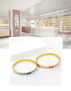 Detail view of blue and pink enamel butterfly bangles with gold-plated metal clasp