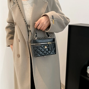 Quilted black vanity bag with gold rose charm and chain strap crossbody style
