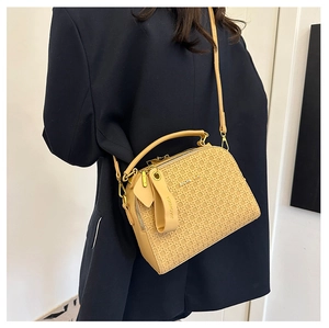 Detail shot of the woven leather texture and JIAONI KA brand charm on the beige handbag