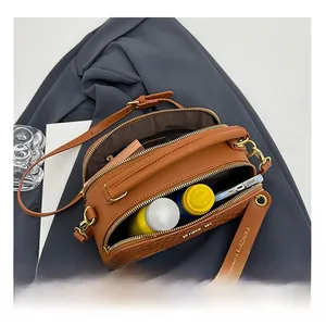 Top view of a brown woven crossbody bag showing large internal capacity for essentials