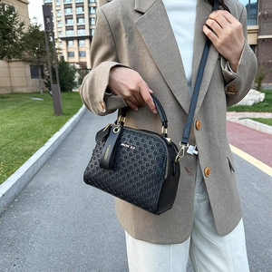 Elegant black woven small square handbag with adjustable shoulder strap and leather handle