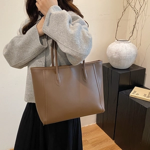 Minimalist brown leather tote bag for women with spacious capacity and elegant shoulder straps