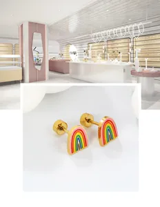 Detailed macro view of rainbow enamel stud earrings with polished gold-plated stainless steel