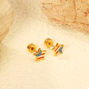 Golden star screw-back earrings with American flag enamel pattern on white stone background