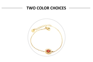 Detail of sunflower pendant with red zircon and white crystals on gold chain