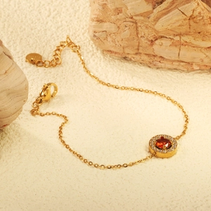 Elegant gold chain bracelet with a round red zircon pendant and white stone halo