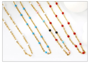 Close-up of colorful enamel beads on gold-plated stainless steel necklace chains
