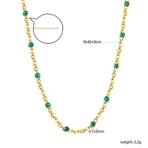 Detail view of 18k gold stainless steel chain necklace with 4.7mm green beads