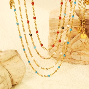 Colorful beaded gold chain necklace featuring vibrant enamel beads in a layered style
