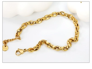Detail showing the lobster clasp and s.steel hallmark on a gold coffee bean link bracelet