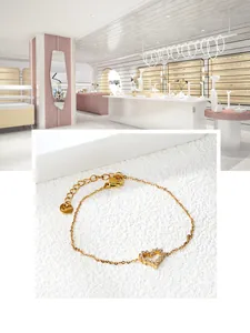Detailed macro view of heart-shaped gold-plated stainless steel bracelet with zircon inlay