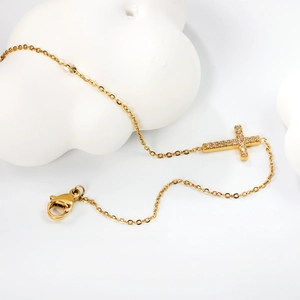Detailed macro view of 18K gold plated cross pendant with shimmering white zircon stones